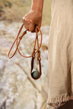 Hand of David holding slingshot with stone